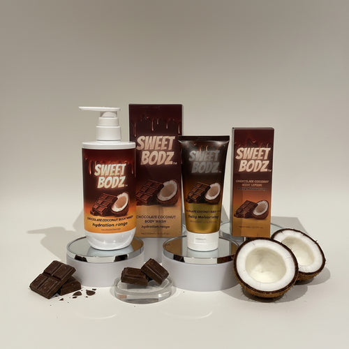 SWEETBODZ® Chocolate Coconut Body Care Bundle featuring body wash, body lotion, packaging, chocolate pieces and coconut halves