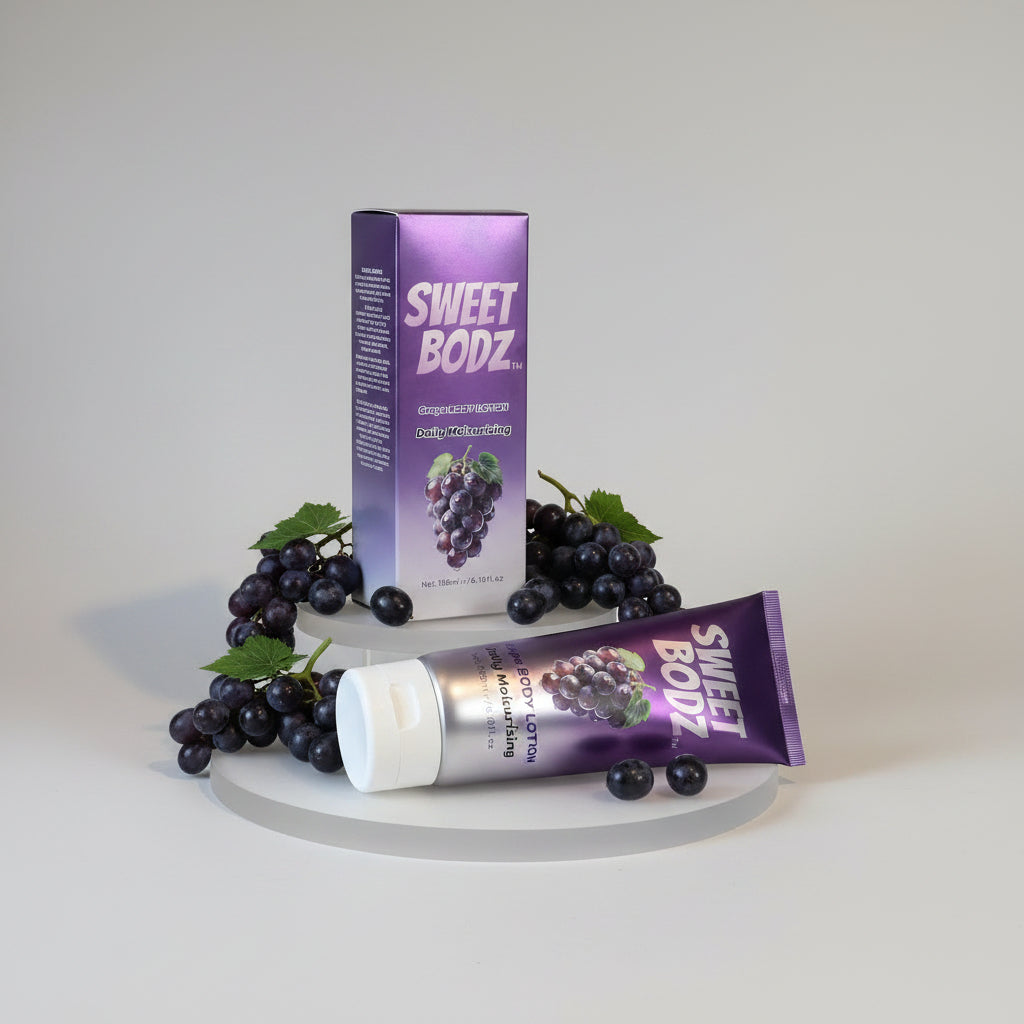 SWEETBODZ Grape Body Lotion 180ml retail product display with fresh grapes on a white background
