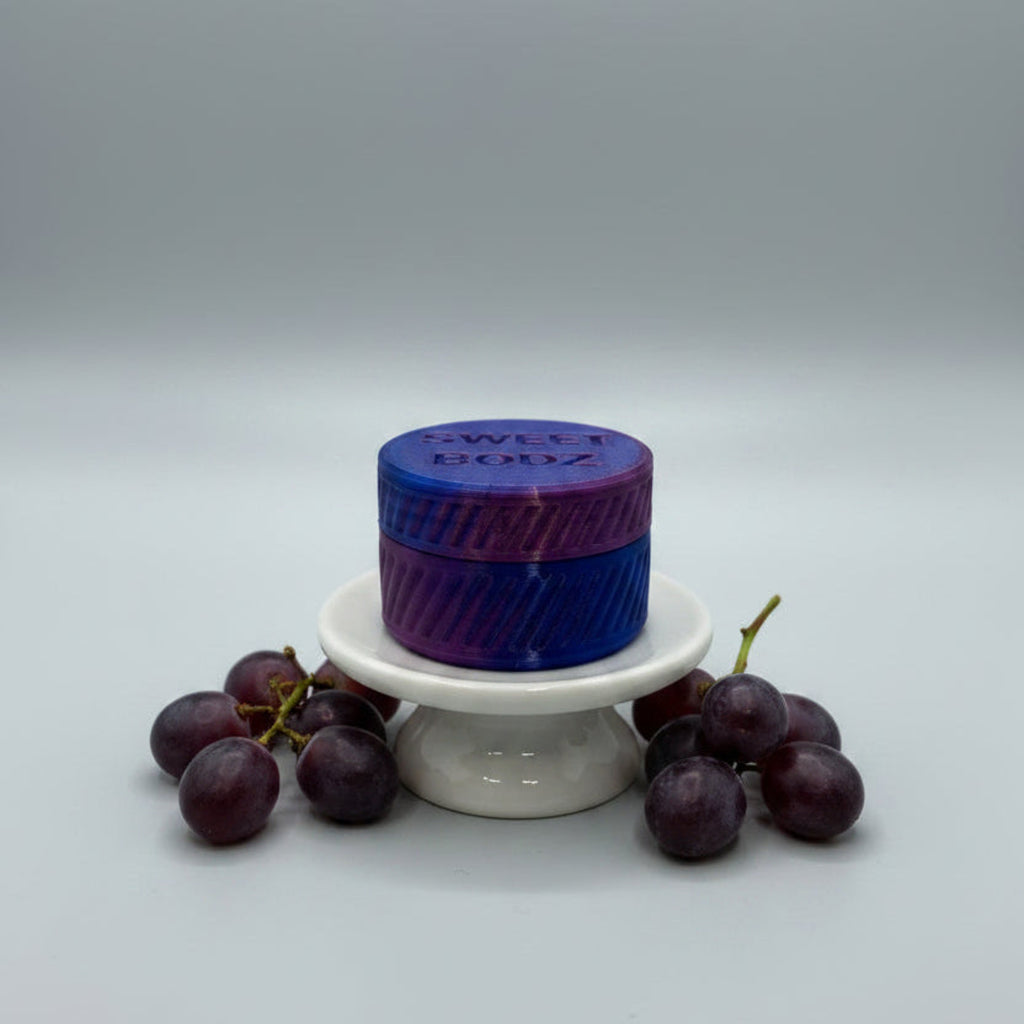 SWEETBODZ Grape Body Lotion Sample Pot 10ml displayed with fresh grapes on a white background