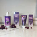 SWEETBODZ Grape Body Wash and Grape Body Lotion displayed with matching product packaging and fresh grapes in a premium body care presentation