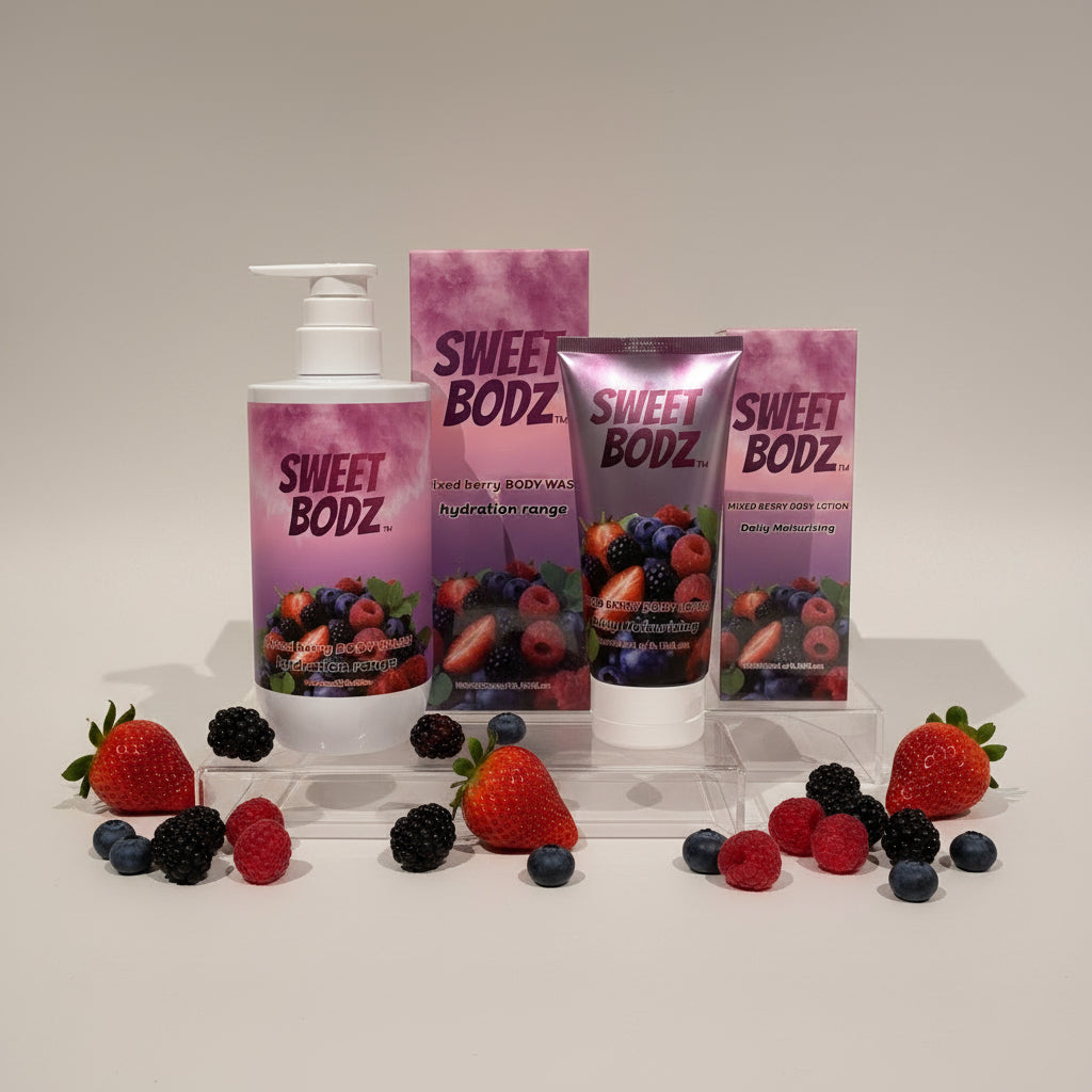 SWEETBODZ Mixed Berry Body Care Bundle featuring body wash, body lotion, fresh strawberries, raspberries, blueberries and blackberries on a studio display.
